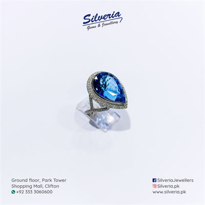 Tear Drop shaped natural blue topaz ring adorned with diamonds in 18kt white Gold
